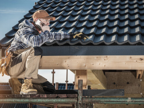 Roof Construction Worker Making Phone Call While Staying on Scaffolding.